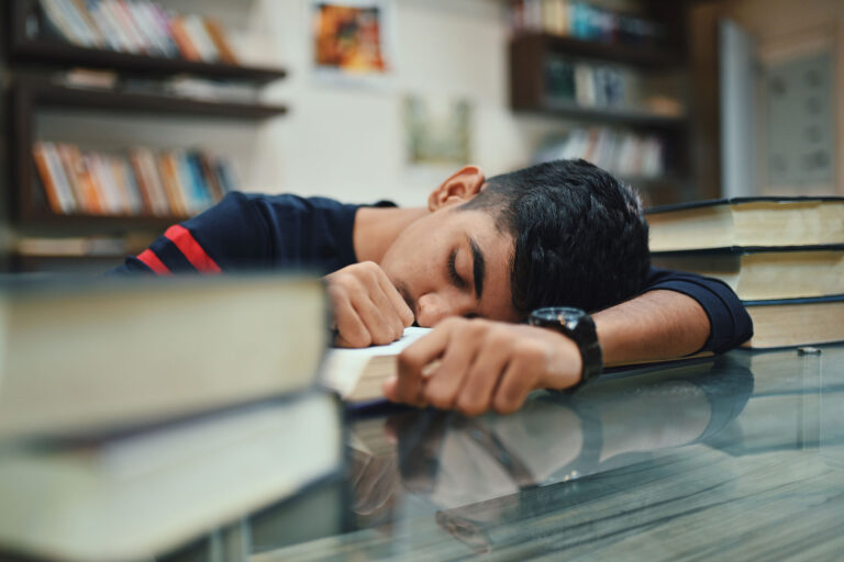 Teenage boy sleeping in the library (Getty Images/Mayur Kakade)