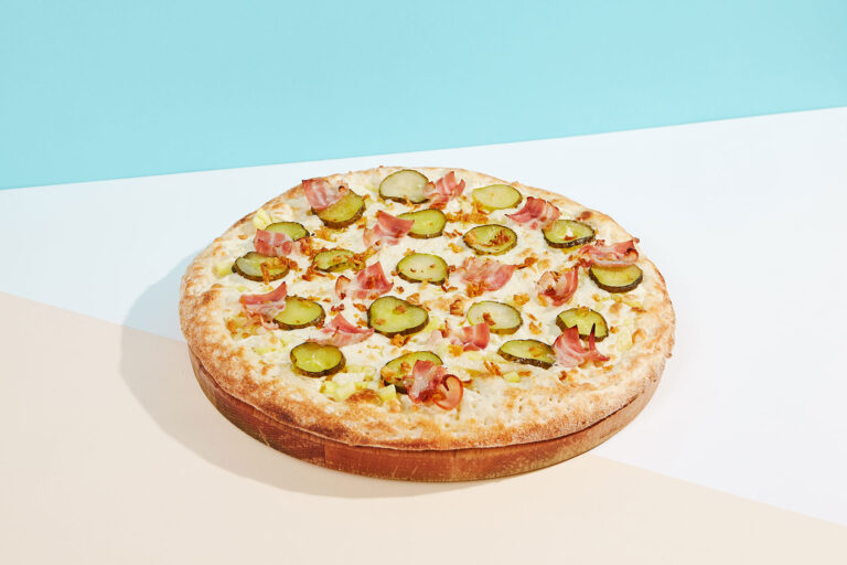Italian pizza with bacon, pickled cucumber and crispy onion (Getty Images/Ryzhkov)