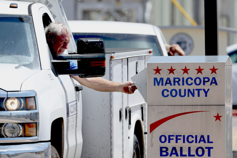 A voter places a ballot in a drop box outside of the Maricopa County Elections Department on August 02, 2022 in Phoenix, Arizona. (Justin Sullivan/Getty Images)