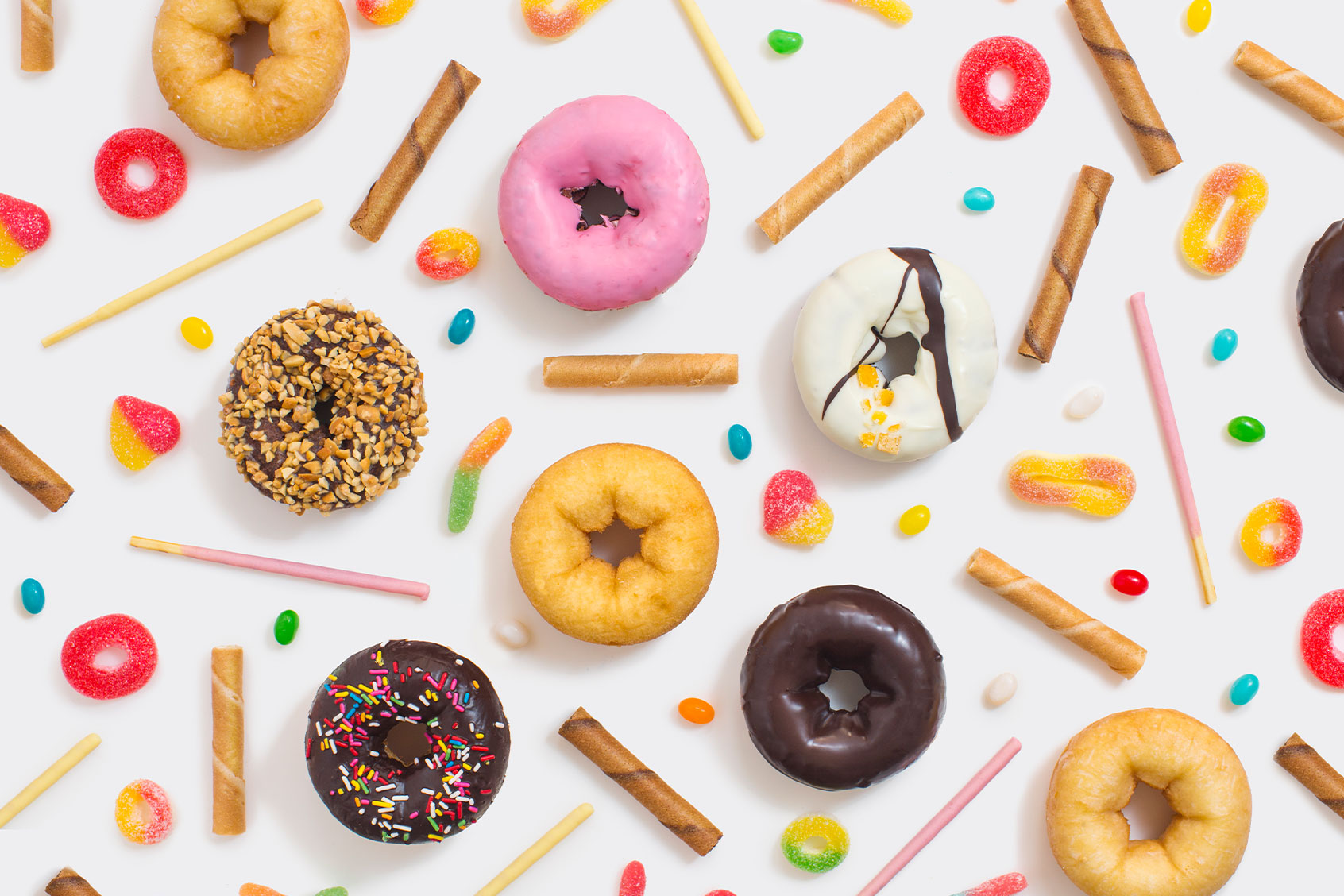 Colourful glazed donuts, candy and snacks (Getty Images/twomeows)