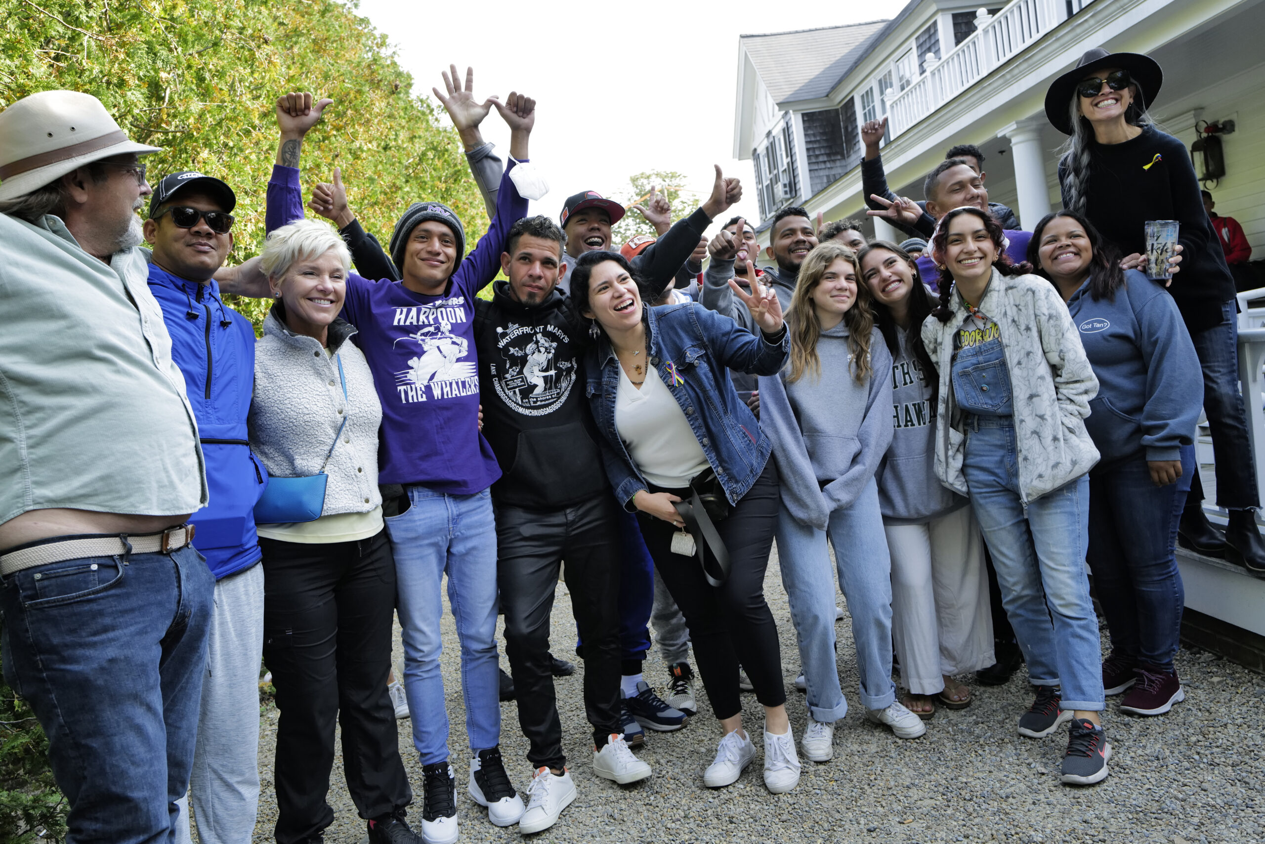 Venezuelan migrants and volunteers celebrate together on Sept. 16 outside St. Andrew's Parish House on Martha's Vineyard. (Carlin Stiehl for the Boston Globe via Getty Images)