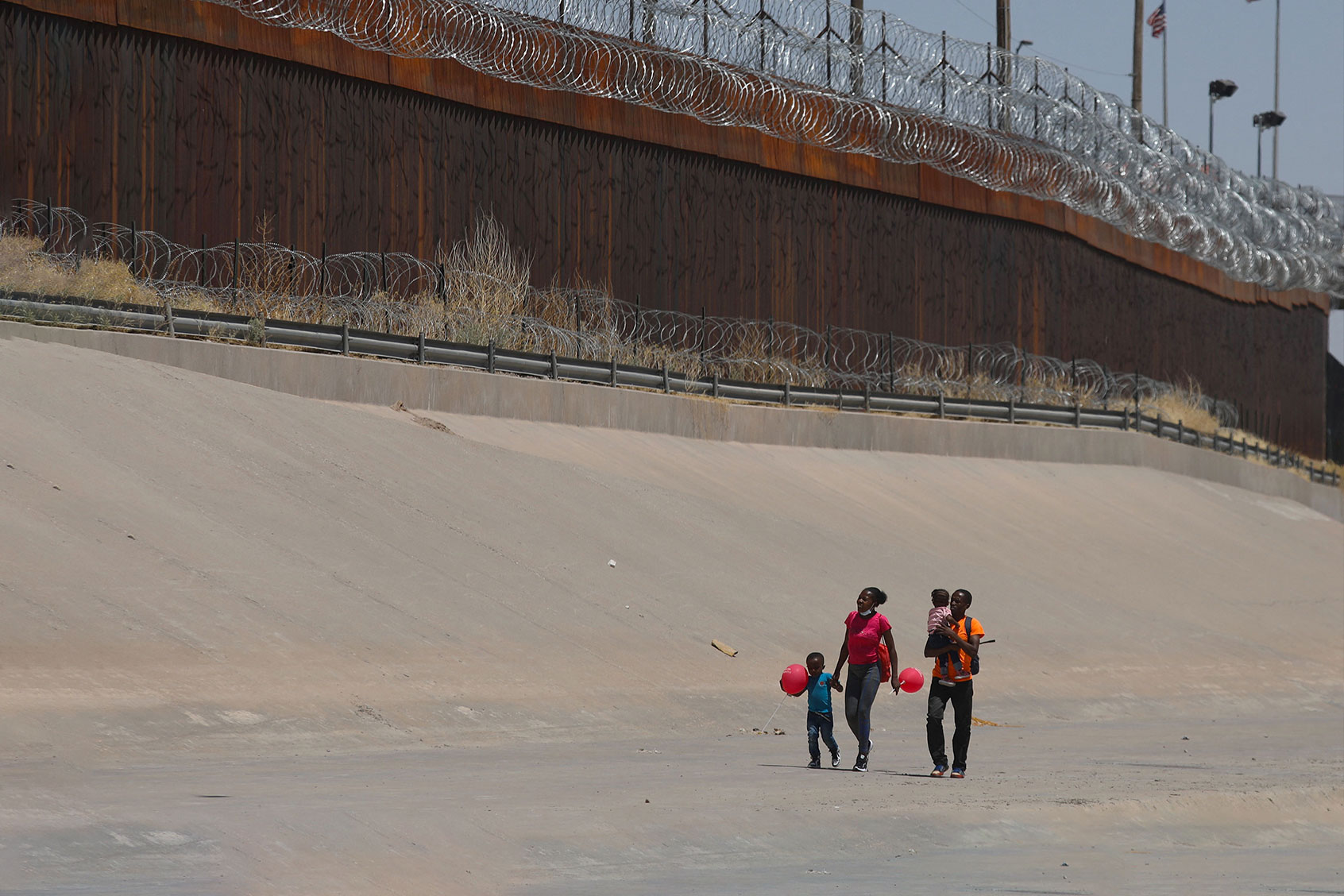Haitian migrants hurry after crossing the Rio Bravo to seek political asylum in the US, as seen from Ciudad Juarez, Chihuahua state, Mexico, on May 20, 2022. (HERIKA MARTINEZ/AFP via Getty Images)