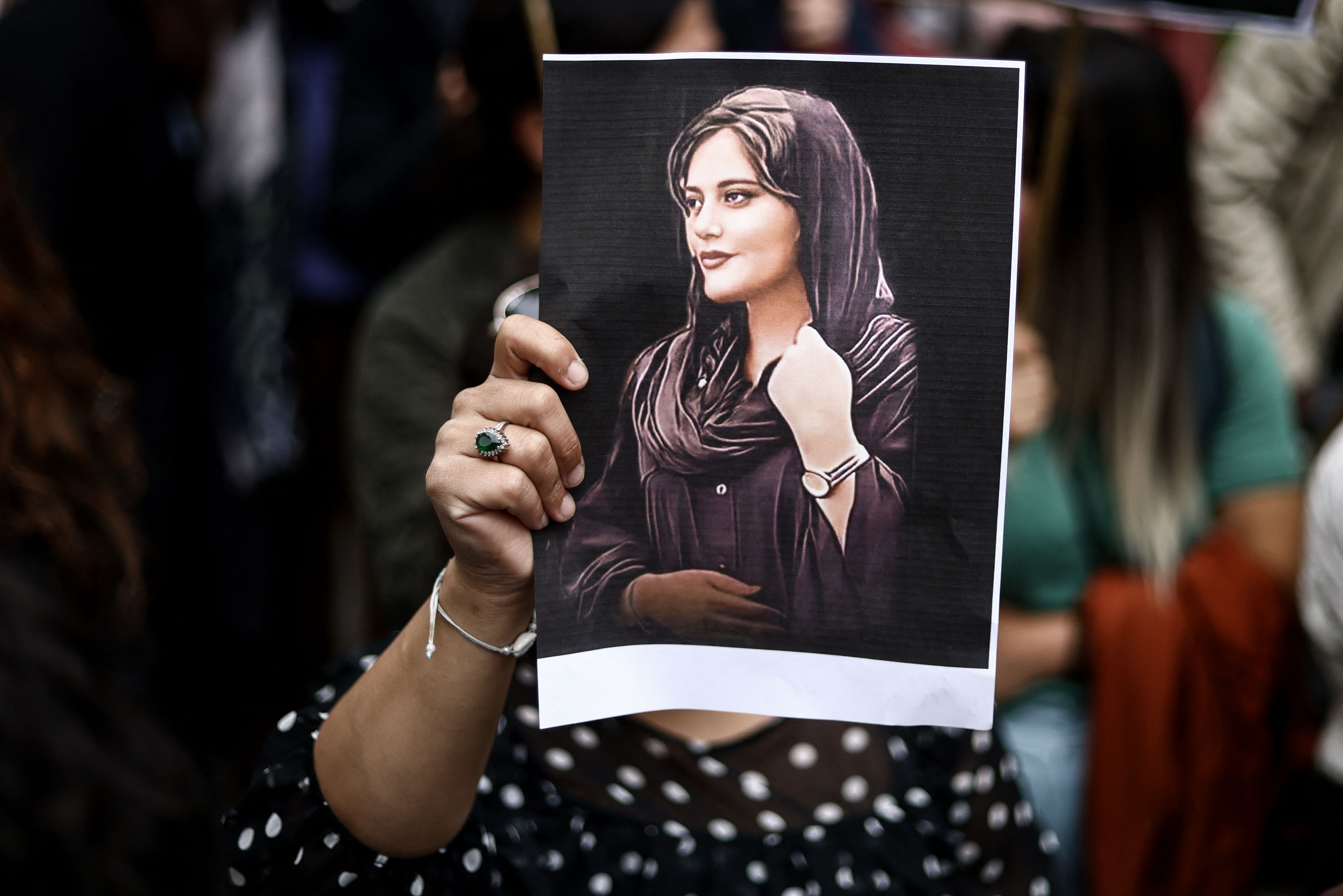 A protester holds a portrait of Mahsa Amini during a demonstration in her support in front of the Iranian embassy in Brussels on September 23, 2022, following the death of an Iranian woman after her arrest by the country's morality police in Tehran. (KENZO TRIBOUILLARD/AFP via Getty Images)