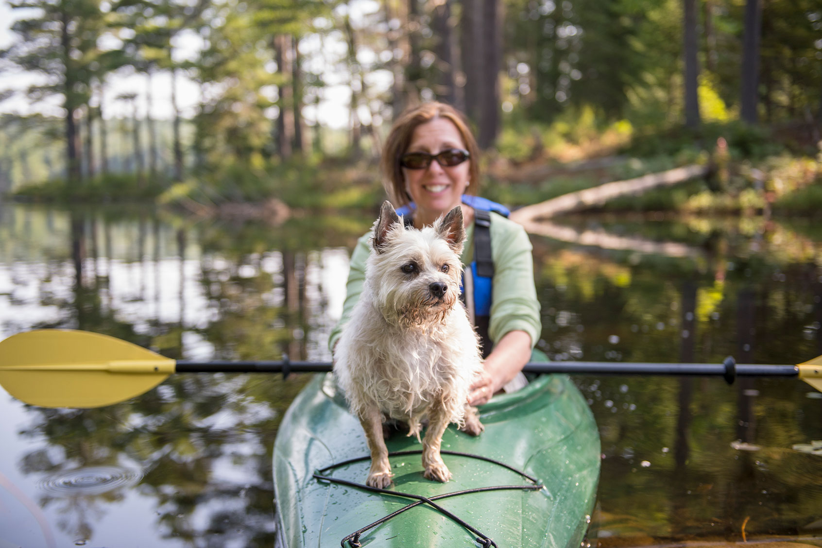 Woman Kayaking with her Dog (Getty Images/Bread and Butter Productions)