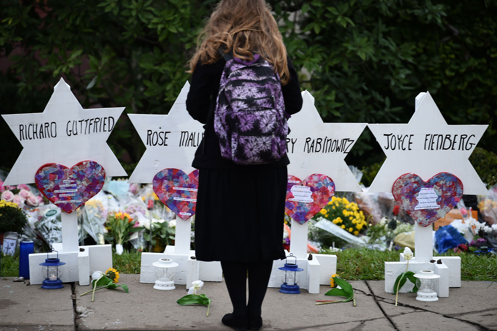 A woman stands at a memorial outside the Tree of Life synagogue after a shooting there left 11 people dead in the Squirrel Hill neighborhood of Pittsburgh on October 27. (BRENDAN SMIALOWSKI/AFP via Getty Images)