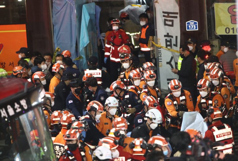 Emergency services treat injured people after a stampede on October 30, 2022 in Seoul, South Korea. (Chung Sung-Jun/Getty Images)