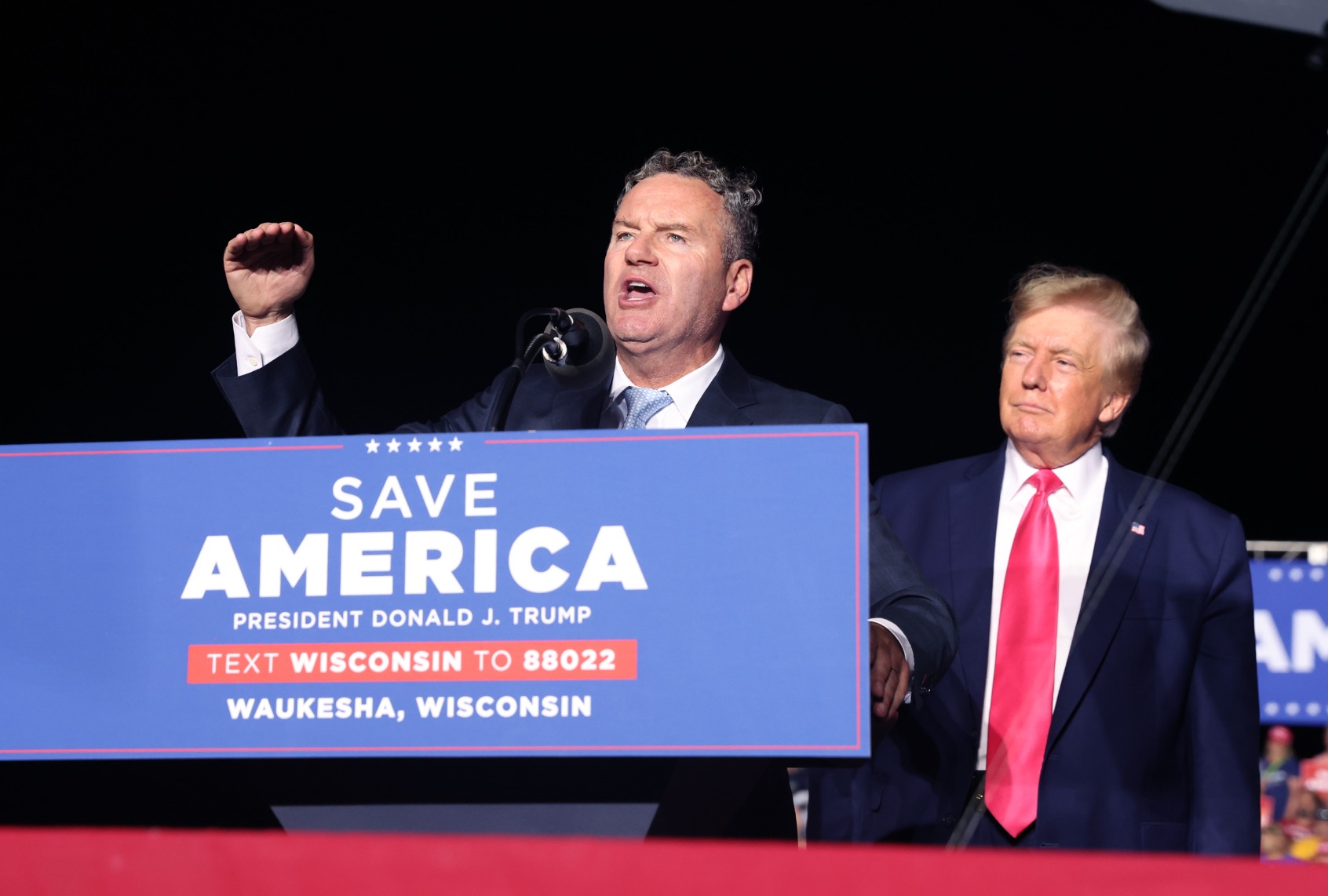 Former President Donald Trump listens as Wisconsin Republican gubernatorial candidate Tim Michels speaks during a rally on August 05, 2022 in Waukesha, Wisconsin. (Scott Olson/Getty Images)