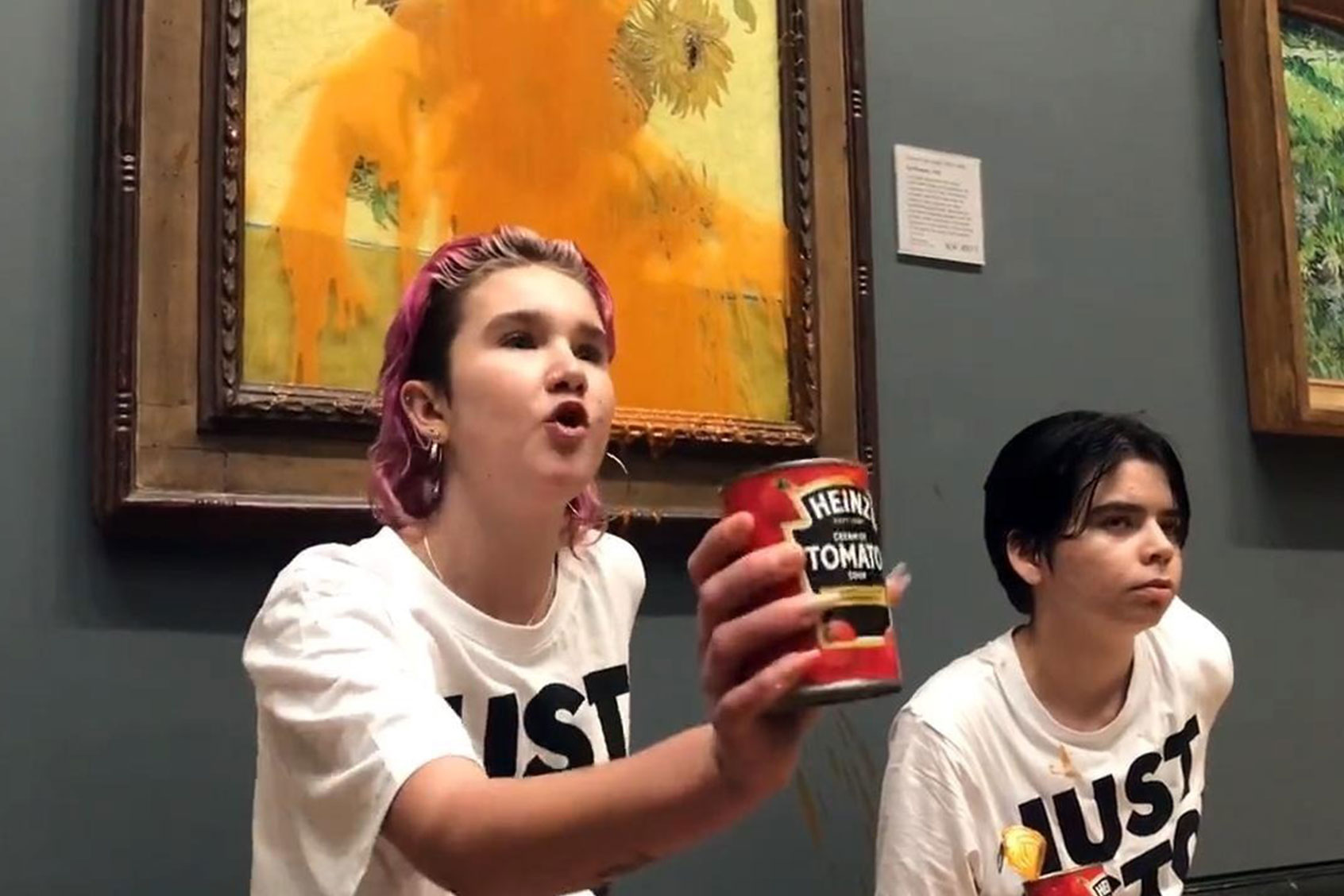 Climate protesters hold a demonstration as they throw cans of tomato soup at Vincent van Gogh's "Sunflowers" at the National Gallery in London, United Kingdom on October 14, 2022. (Just Stop Oil / Handout/Anadolu Agency via Getty Images)