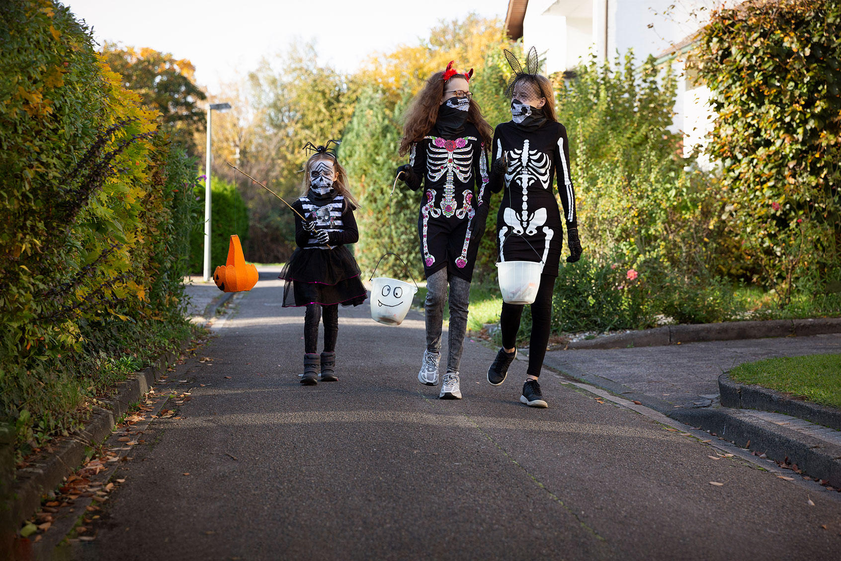 Child and teenagers walking along a narrow urban street whilst out trick or treating for Halloween (Getty Images/Elva Etienne)