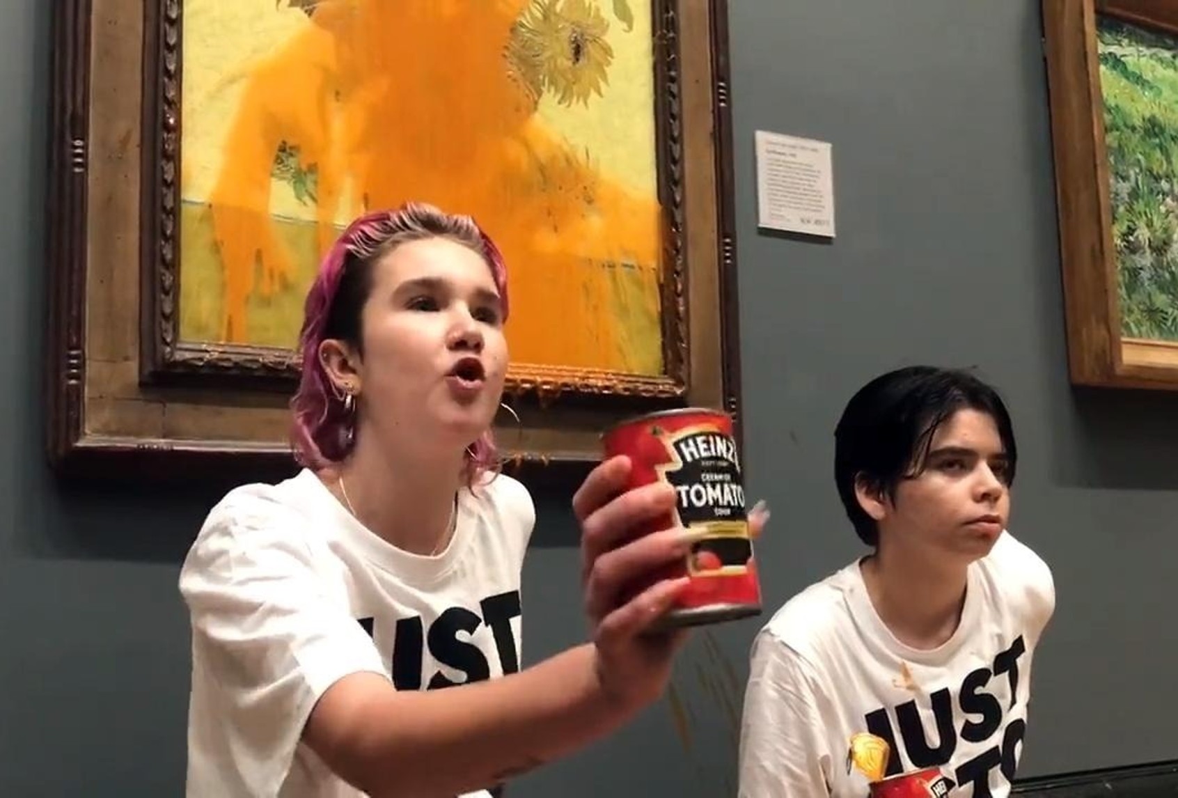 Climate protesters hold a demonstration as they throw cans of tomato soup at Van Gogh's Sunflowers at the National Gallery in London, United Kingdom on October 14, 2022. (Just Stop Oil / Handout/Anadolu Agency via Getty Images)