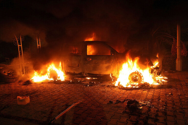 A vehicle and the surrounding area are engulfed in flames after it was set on fire inside the U.S. consulate compound in Benghazi, Libya, on Sept. 11, 2012. (STR/AFP via Getty Images)