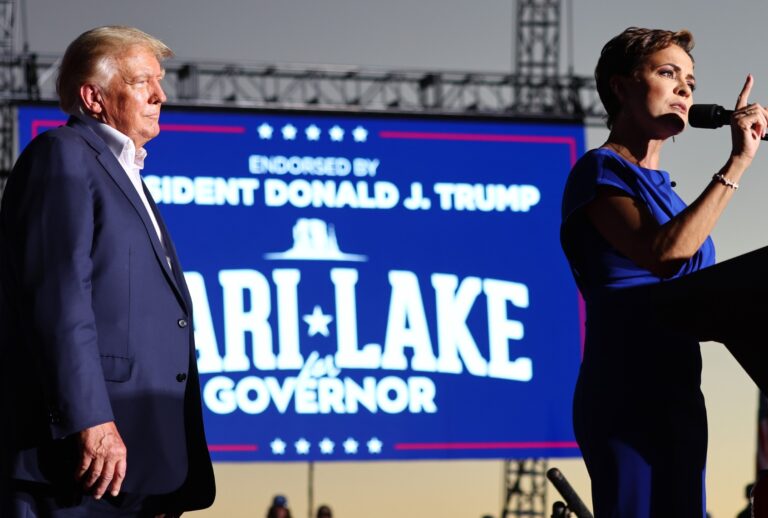 Former President Donald Trump looks on as Arizona Republican nominee for governor Kari Lake speaks during a campaign rally on October 09, 2022 in Mesa, Arizona. (Mario Tama/Getty Images)
