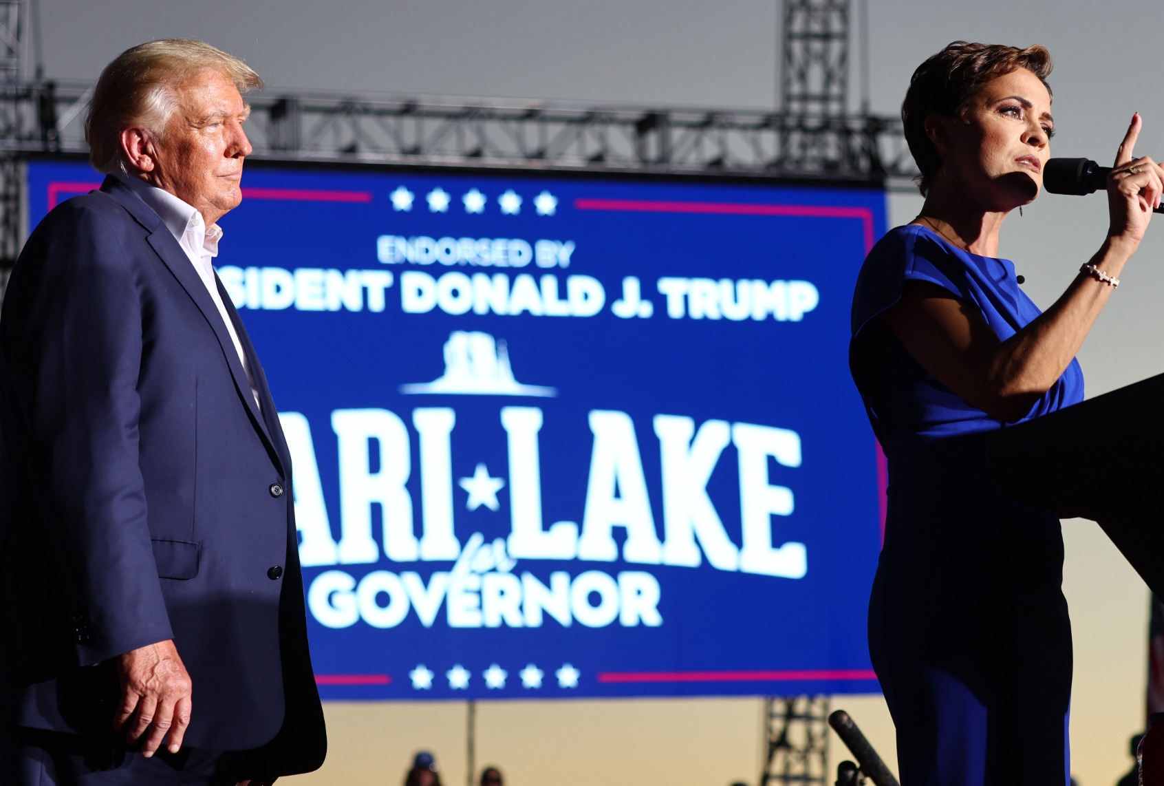 Former President Donald Trump looks on as Arizona Republican nominee for governor Kari Lake speaks during a campaign rally on October 09, 2022 in Mesa, Arizona. (Mario Tama/Getty Images)