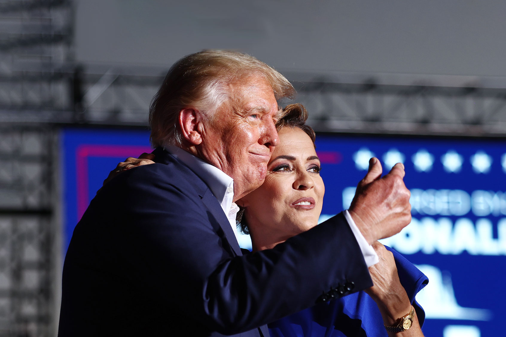 Former U.S. President Donald Trump embraces Arizona Republican gubernatorial nominee Kari Lake at a campaign rally at Legacy Sports USA on October 09, 2022 in Mesa, Arizona. (Mario Tama/Getty Images)