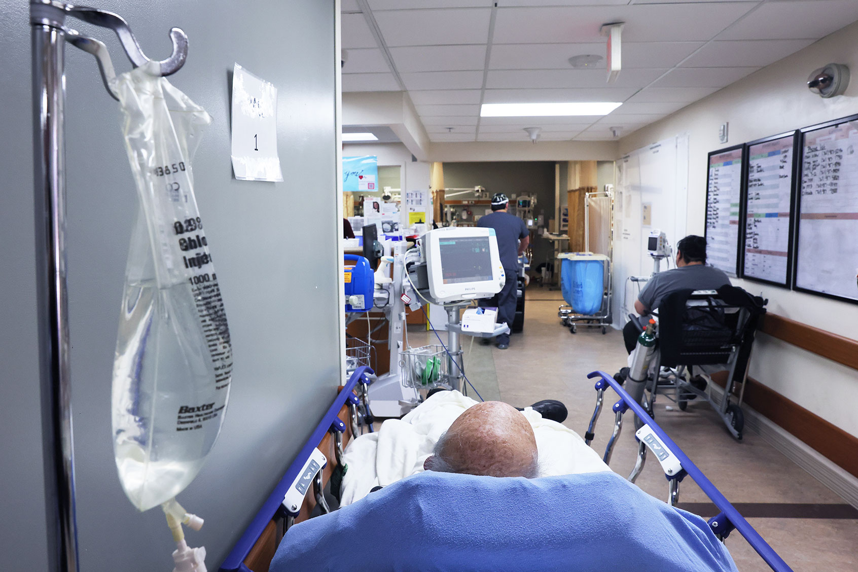 Patients rest in a hallway in the overloaded Emergency Room area at Providence St. Mary Medical Center on January 27, 2021 in Apple Valley, California. (Mario Tama/Getty Images)