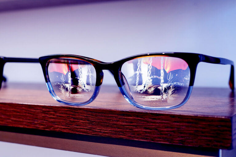 Prisoners reflected in glasses on a shelf (Photo illustration by Salon/Getty Images)