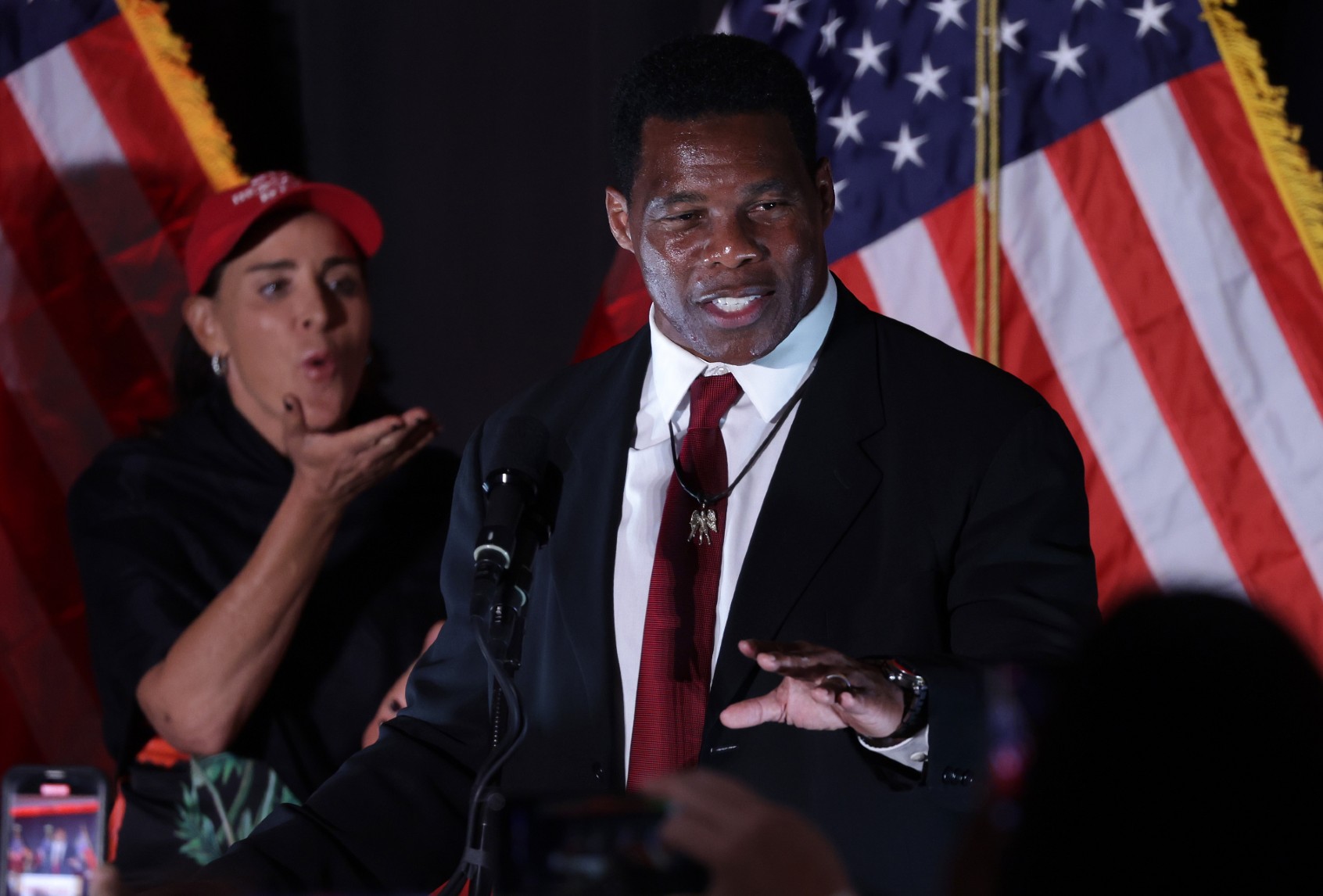 Republican U.S. Senate candidate Herschel Walker speaks to supporters as his wife Julie Blanchard looks on during an election night event on November 8, 2022 in Atlanta, Georgia. (Alex Wong/Getty Images)