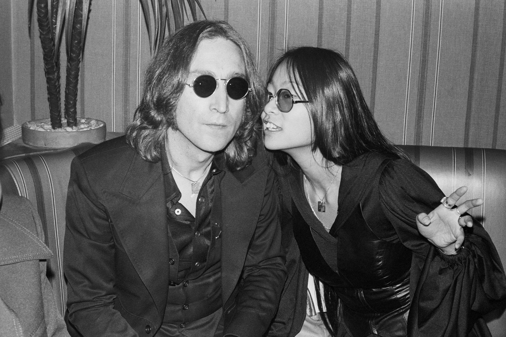May Pang and John Lennon sitting in club; circa 1970; New York. (Art Zelin/Getty Images)