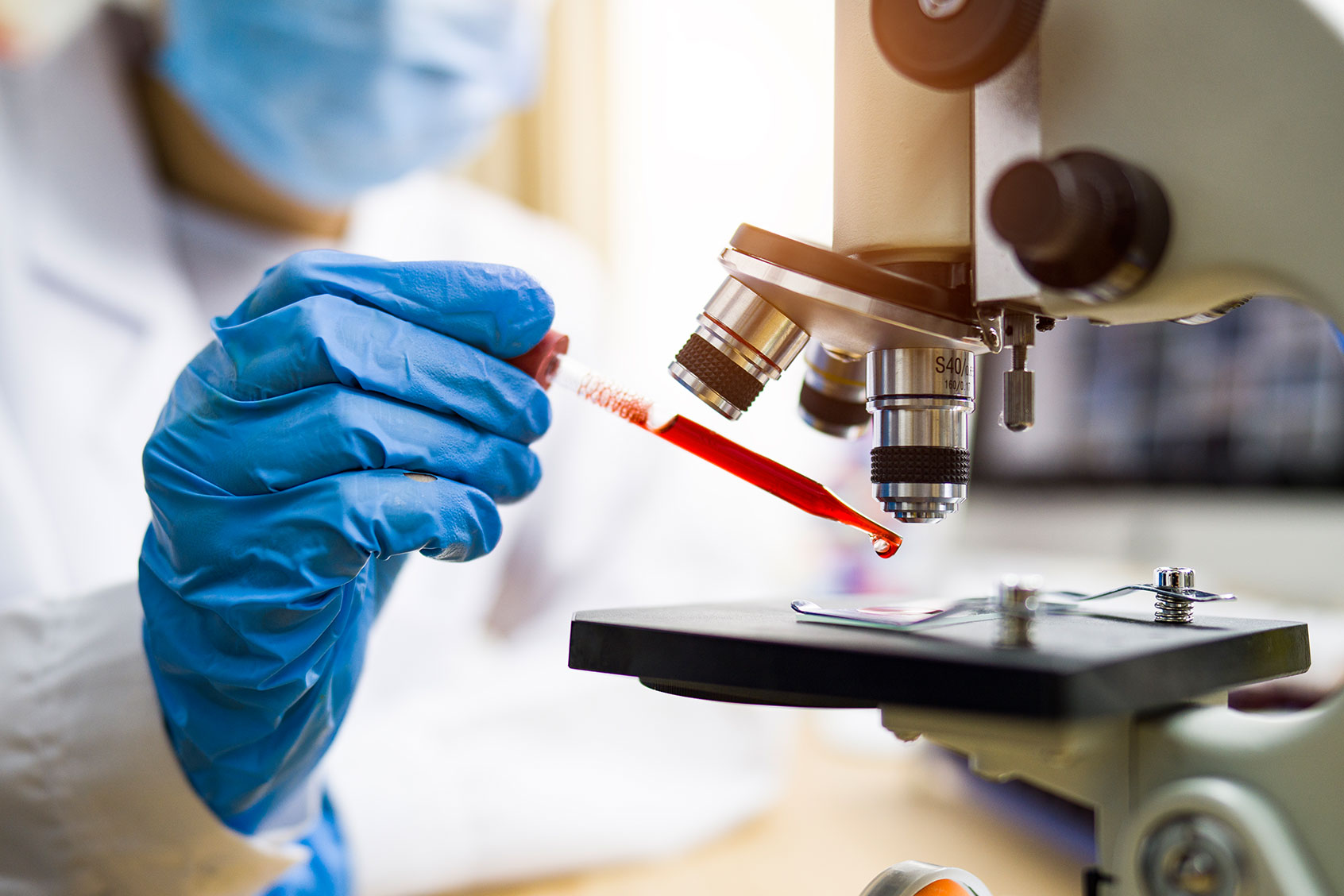 Scientist looking at blood sample (Getty Images/Thana Prasongsin)