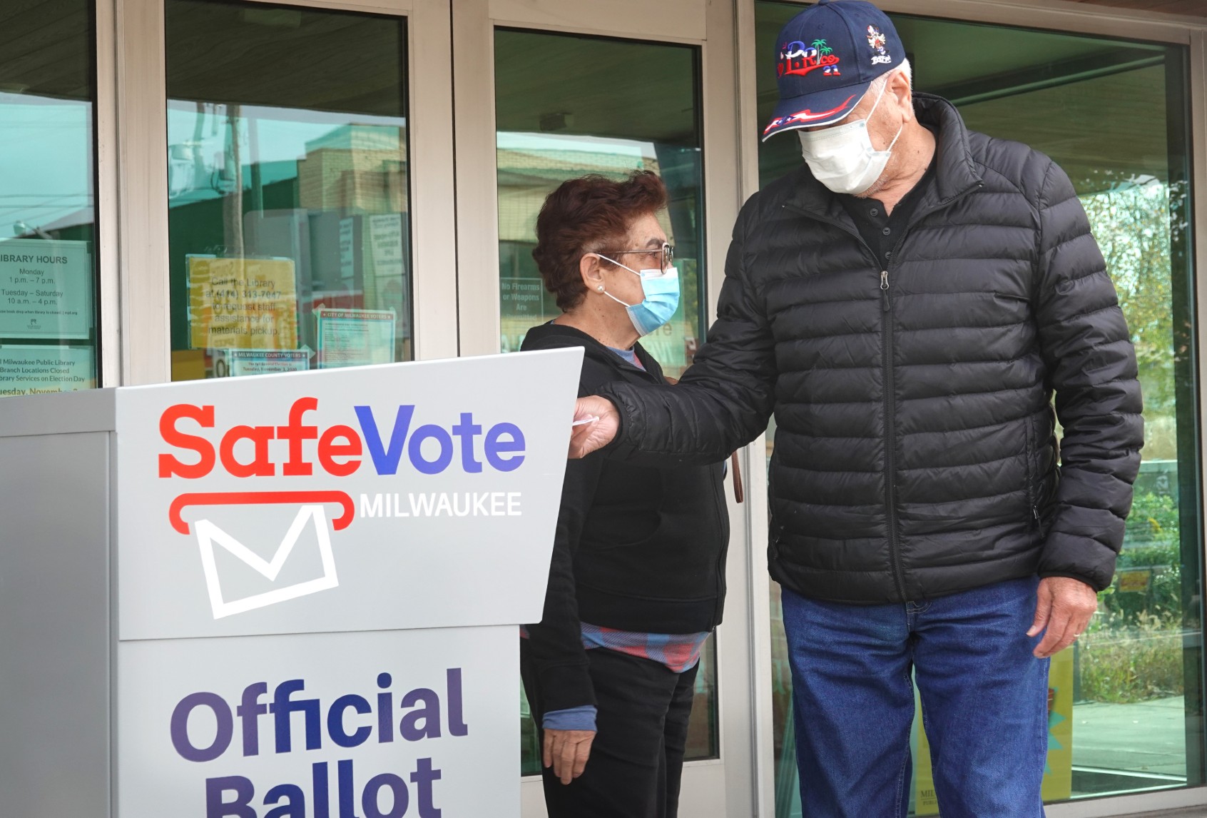 Residents drop mail-in ballots in an official ballot box outside of the Tippecanoe branch library on October 20, 2020 in Milwaukee, Wisconsin. (Scott Olson/Getty Images)