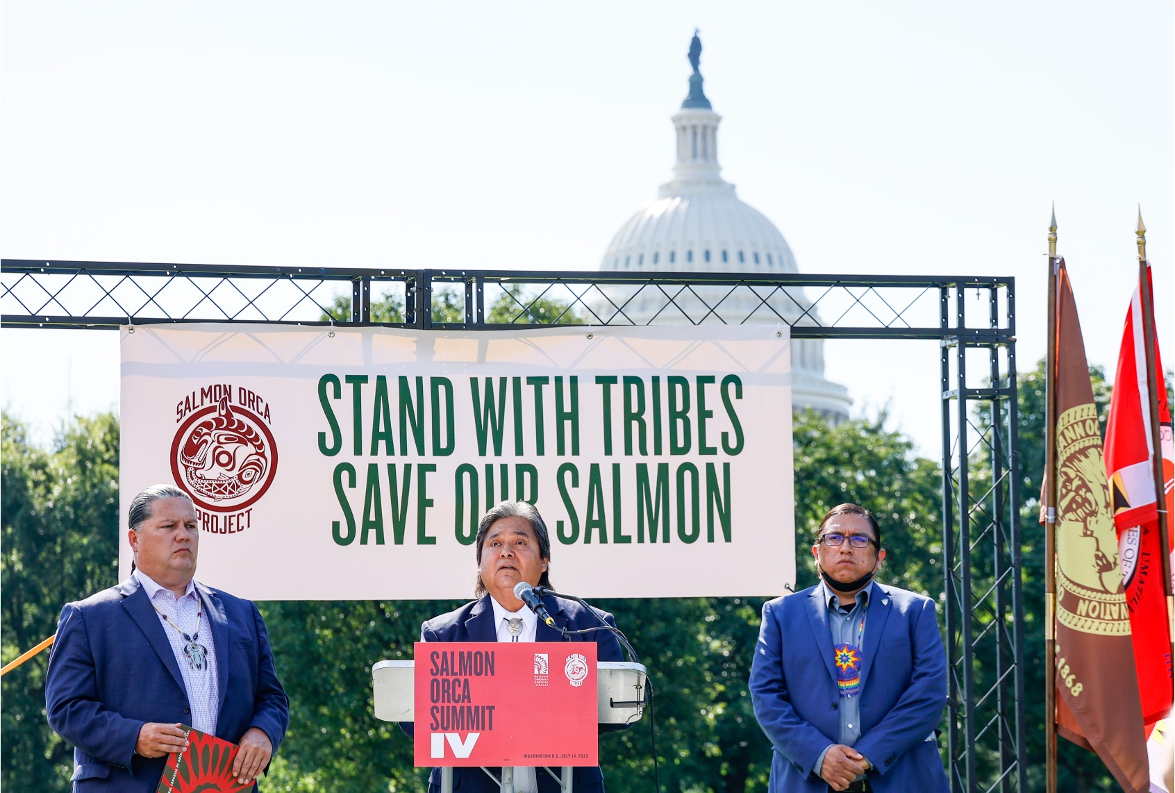 Samuel Penney, chairman of the Nez Perce Tribe speaks as Larry Wright of the National Congress of American Indians (L) and Jeremy Takala Yakama of the Yakama Nation (R) look on during the Salmon Orca Summit IV on the grounds of the US Capitol on July 14, 2022 in Washington, DC. (Jemal Countess/Getty Images for Nez Perce Tribe)