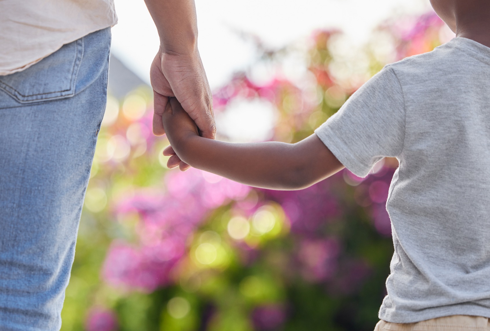 Closeup father and son holding hands. (PeopleImages/Getty Images)