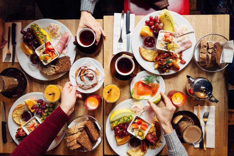 Group of friends having celebration dinner together (Getty Images/Alexander Spatari)