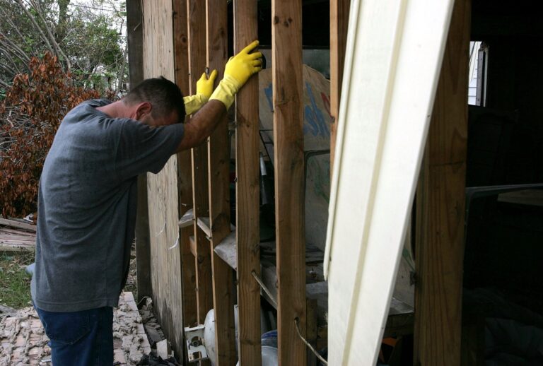 A St. Bernard Parish resident cries as he removes debris from his home September 17, 2005 in Chalmette, Louisiana. (Justin Sullivan/Getty Images)