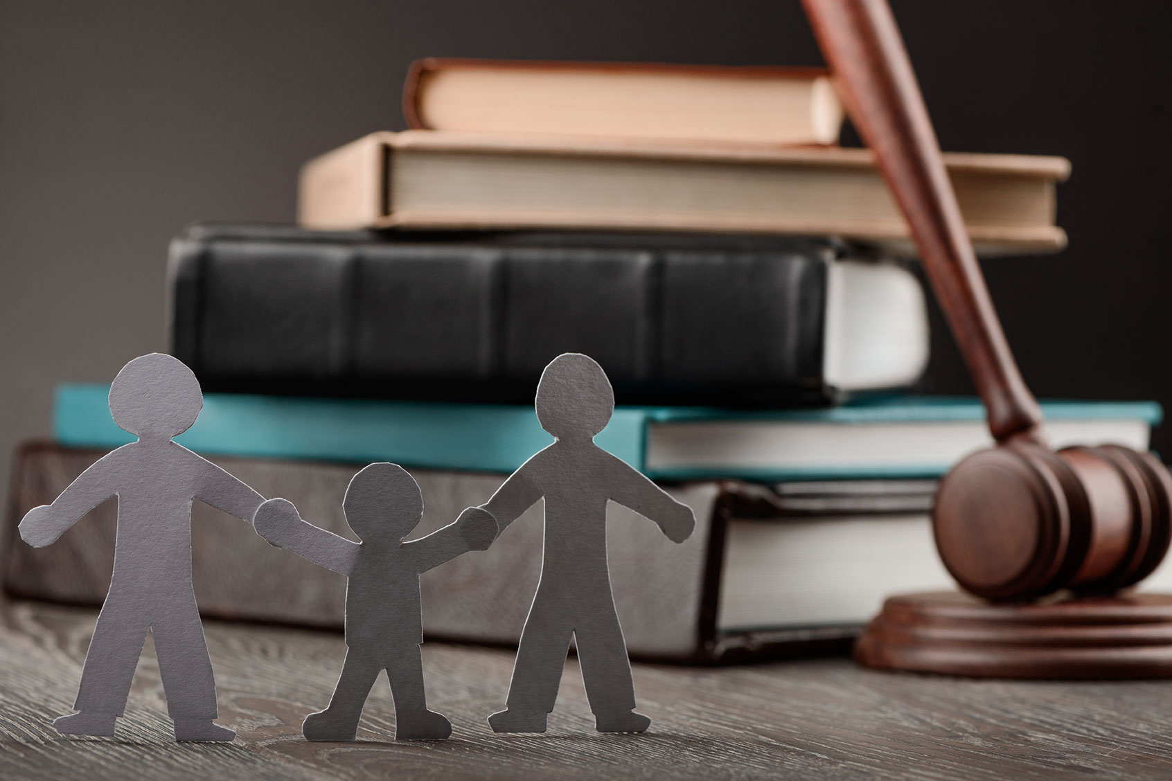 Paper people chain, law books and judge's gavel (Getty Images/YGolub)