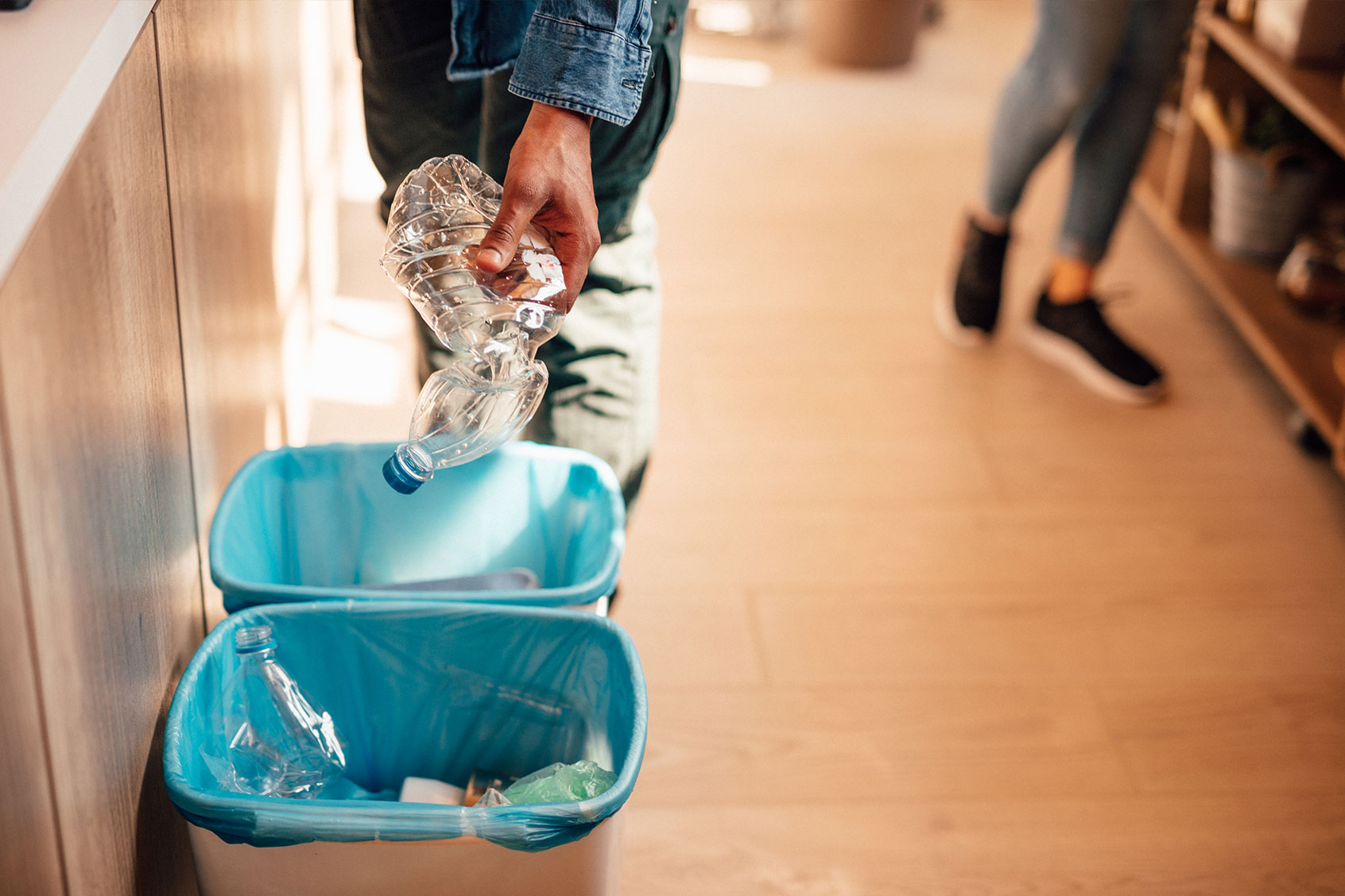 Plastic bottle being put in recycling bin (Getty Images/Anchiy)