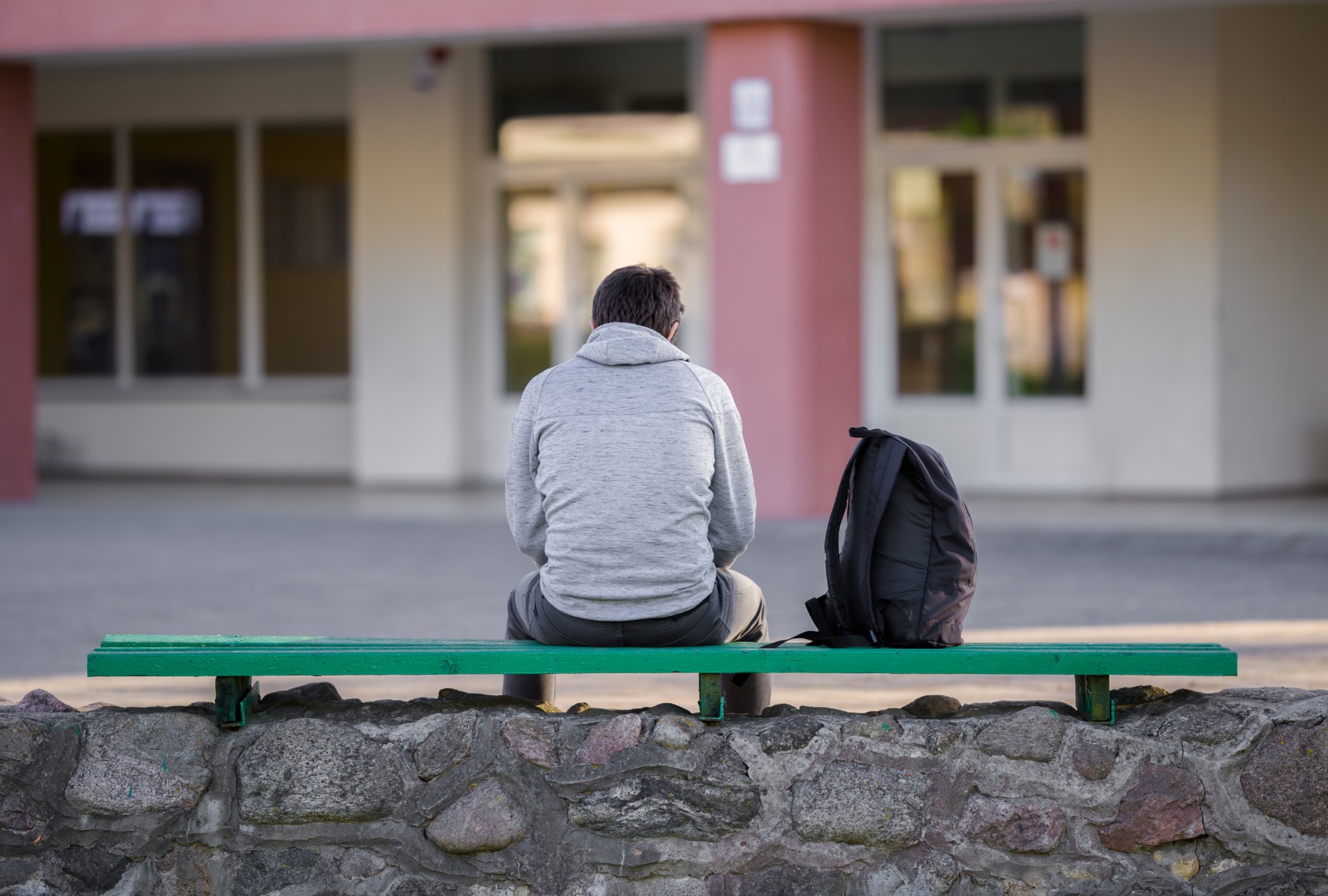 Student in school yard. (FotoDuets/Getty Images)