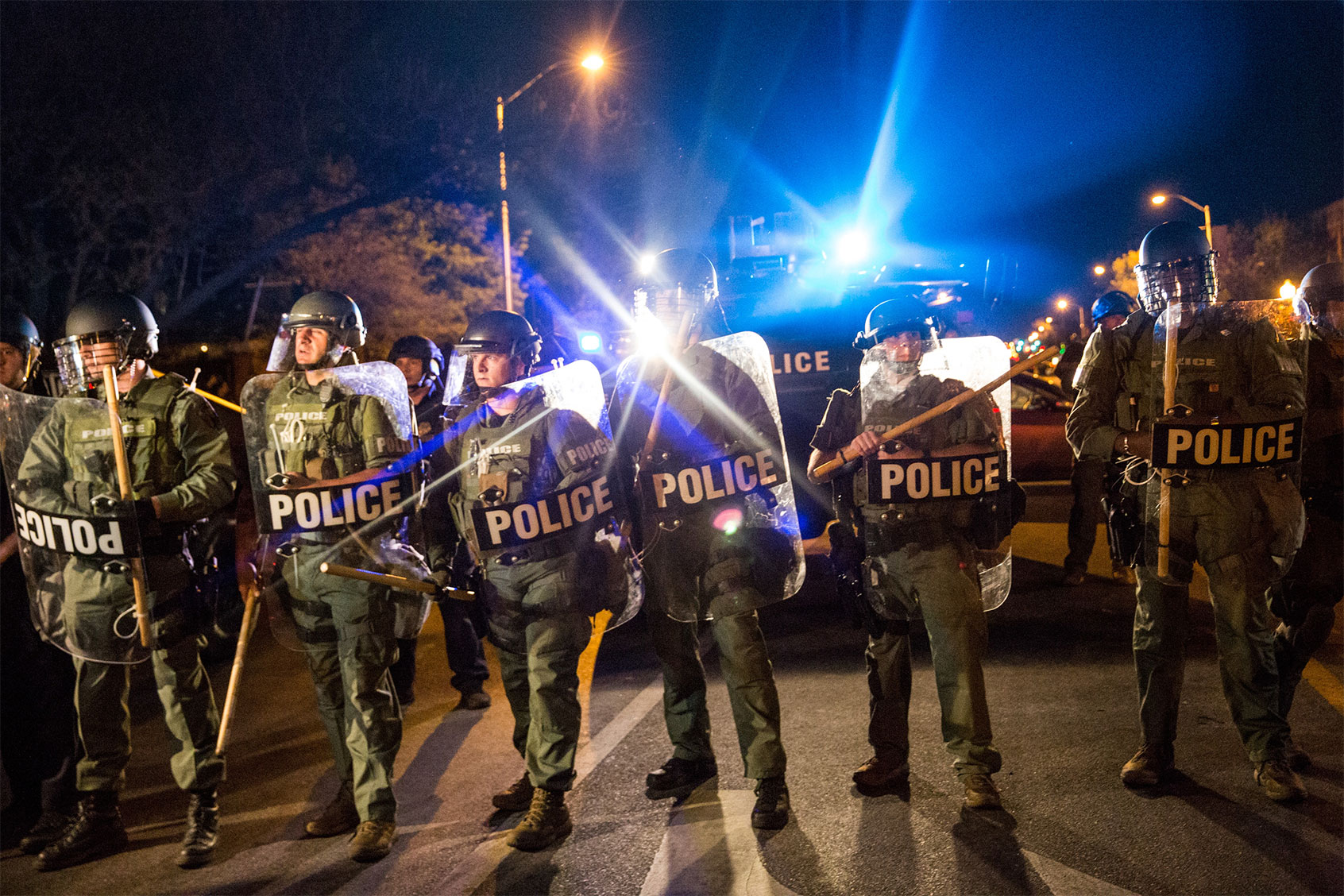 Riot police monitor protesters near a CVS pharmacy that was looted and burned by rioters on Monday after the funeral of Freddie Gray, on April 29, 2015 in Baltimore, Maryland. (Andrew Burton/Getty Images)