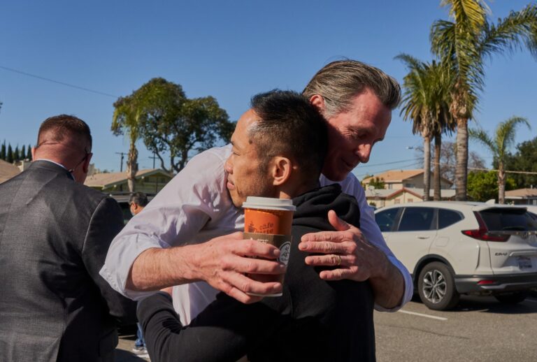 California Governor Gavin Newsom hugs Thinh Luong, 46, a school teacher, near the Star Dance Studio in Monterey Park, California on January 23, 2023. (Philip Cheung for The Washington Post via Getty Images)
