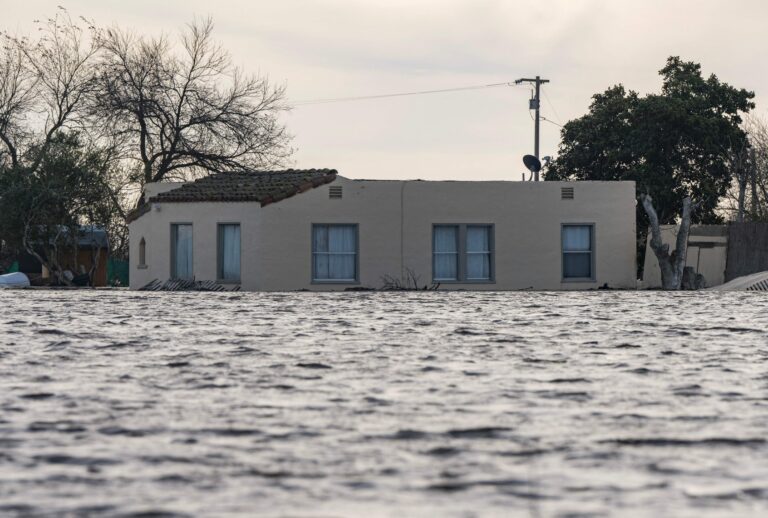 A house is submerged in floodwaters from the Salinas River near Chualar, California, on January 12, 2023. (NIC COURY/AFP via Getty Images)