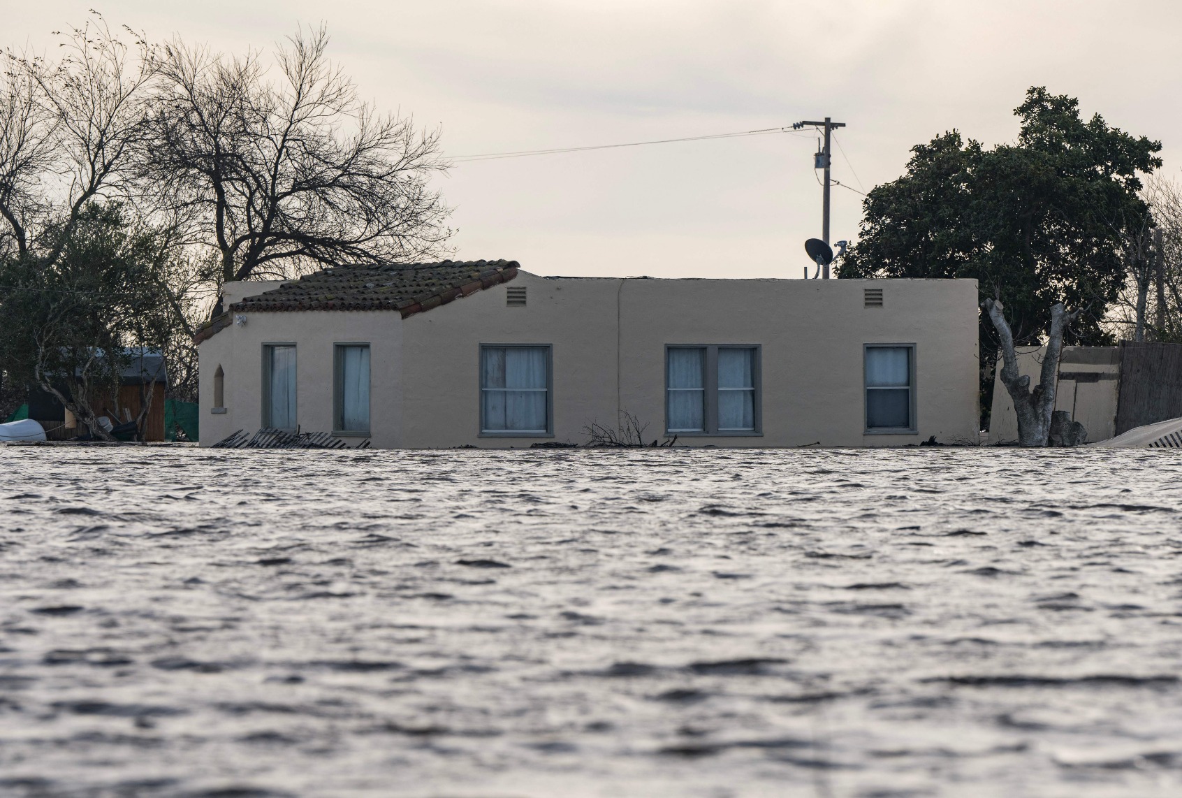 A house is submerged in floodwaters from the Salinas River near Chualar, California, on January 12, 2023. (NIC COURY/AFP via Getty Images)