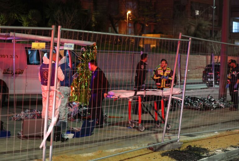 Israeli emergency service personnel transport casualties at the site of a reported attack in a settler neighborhood of Israeli-annexed east Jerusalem, on January 27, 2023. (AHMAD GHARABLI/AFP via Getty Images)