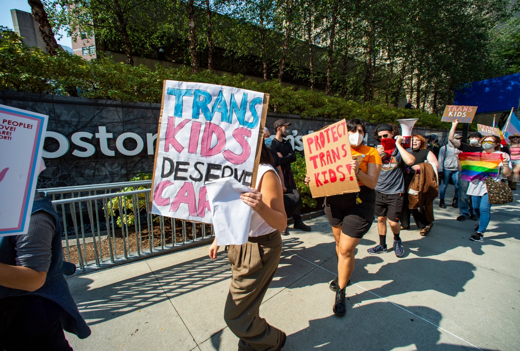 Demonstrators carry signs in support of trans-children and gender affirmation treatments during a rally outside of Boston Childrens Hospital in Boston, Massachusetts, on September 18, 2022. (JOSEPH PREZIOSO/AFP via Getty Images)