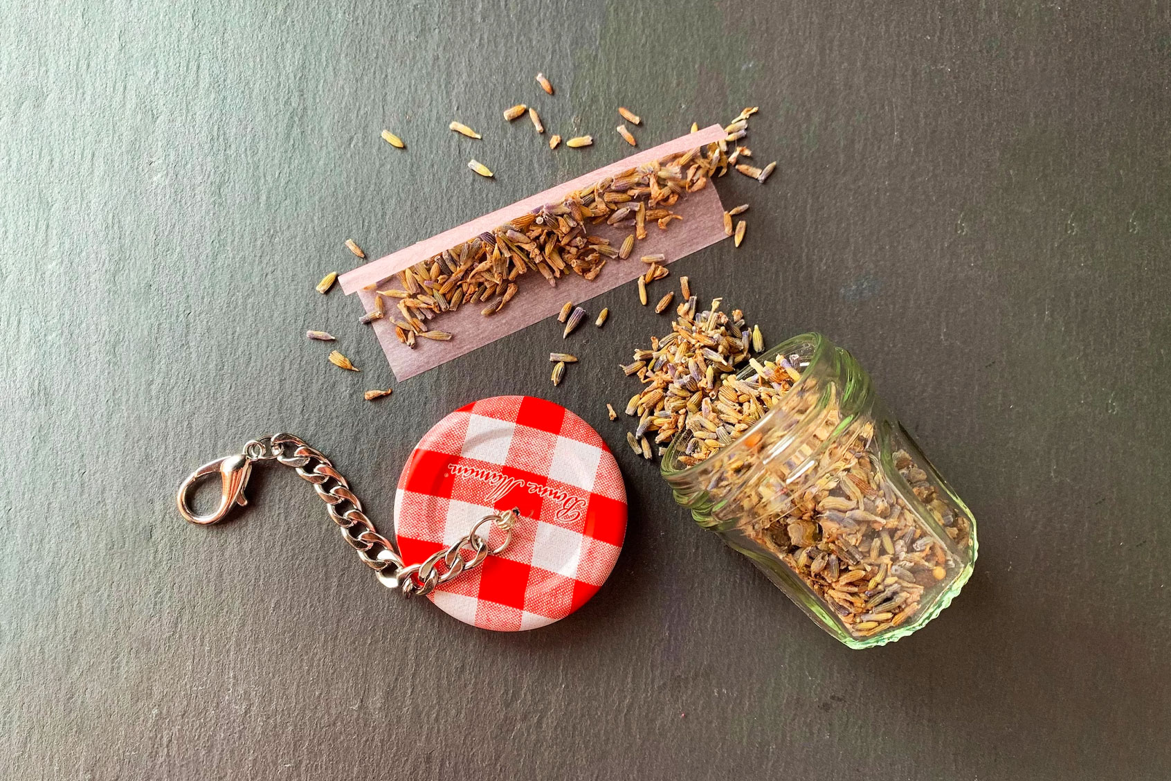 1 oz Bonne Maman jam jar upcycled into a keychain (Etsy / <a href="https://www.etsy.com/listing/1381980696/stash-jar-keychain-bonne-maman" target="_blank">dewdropdoobie</a>)