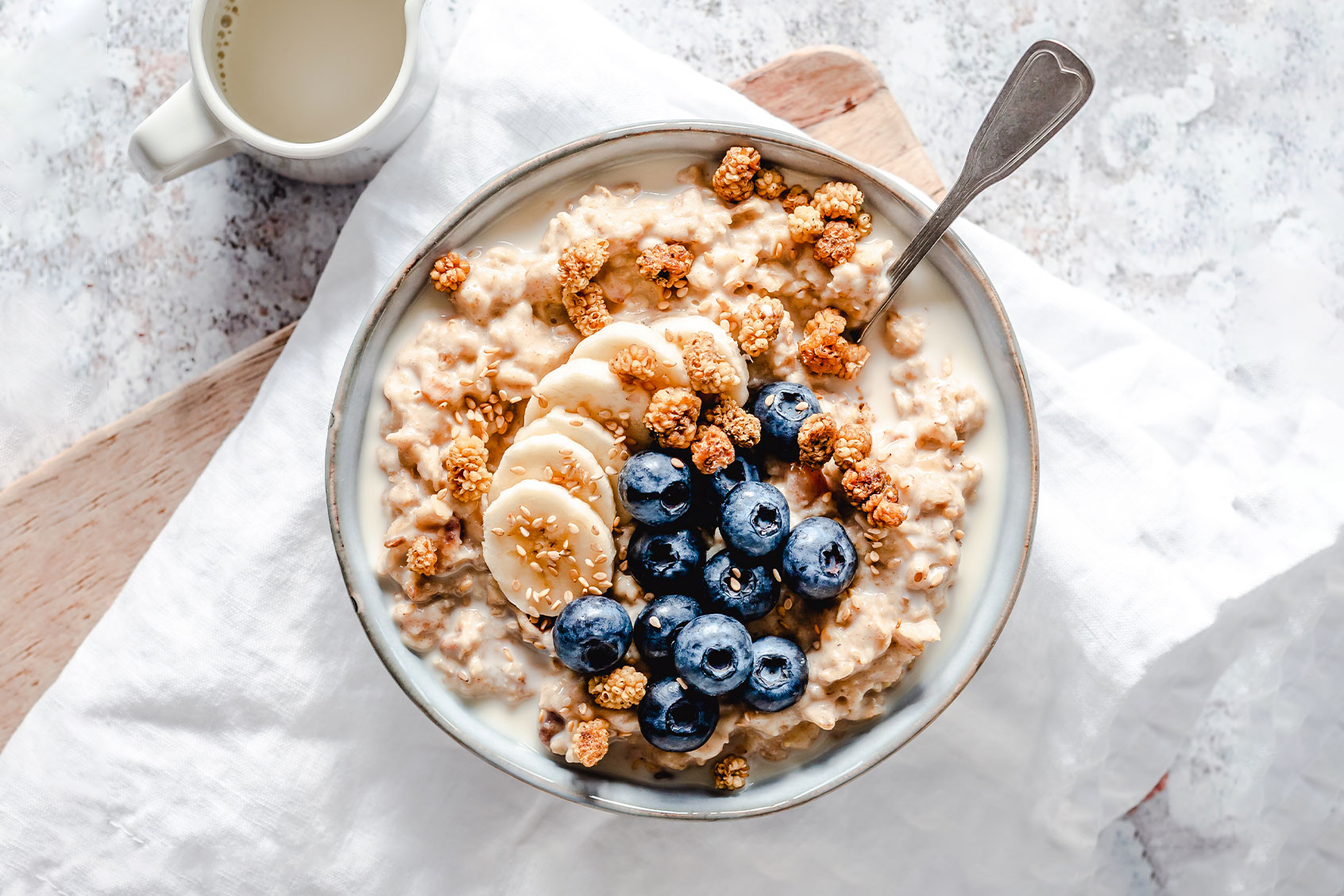 Creamy oatmeal bowl with banana, blueberries, mulberries and sesame seeds (Getty Images/OatmealStories)