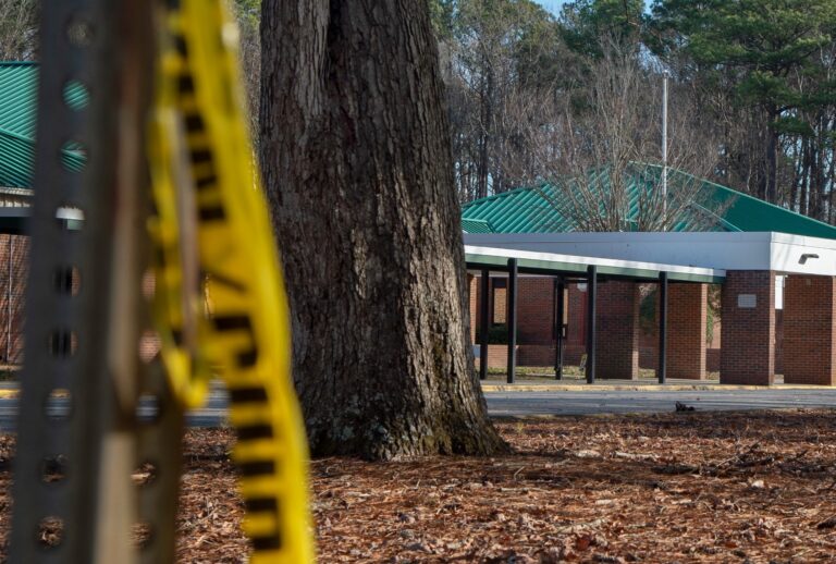 Police tape hangs from a sign post outside Richneck Elementary School following a shooting on January 7, 2023 in Newport News, Virginia. (Jay Paul/Getty Images)
