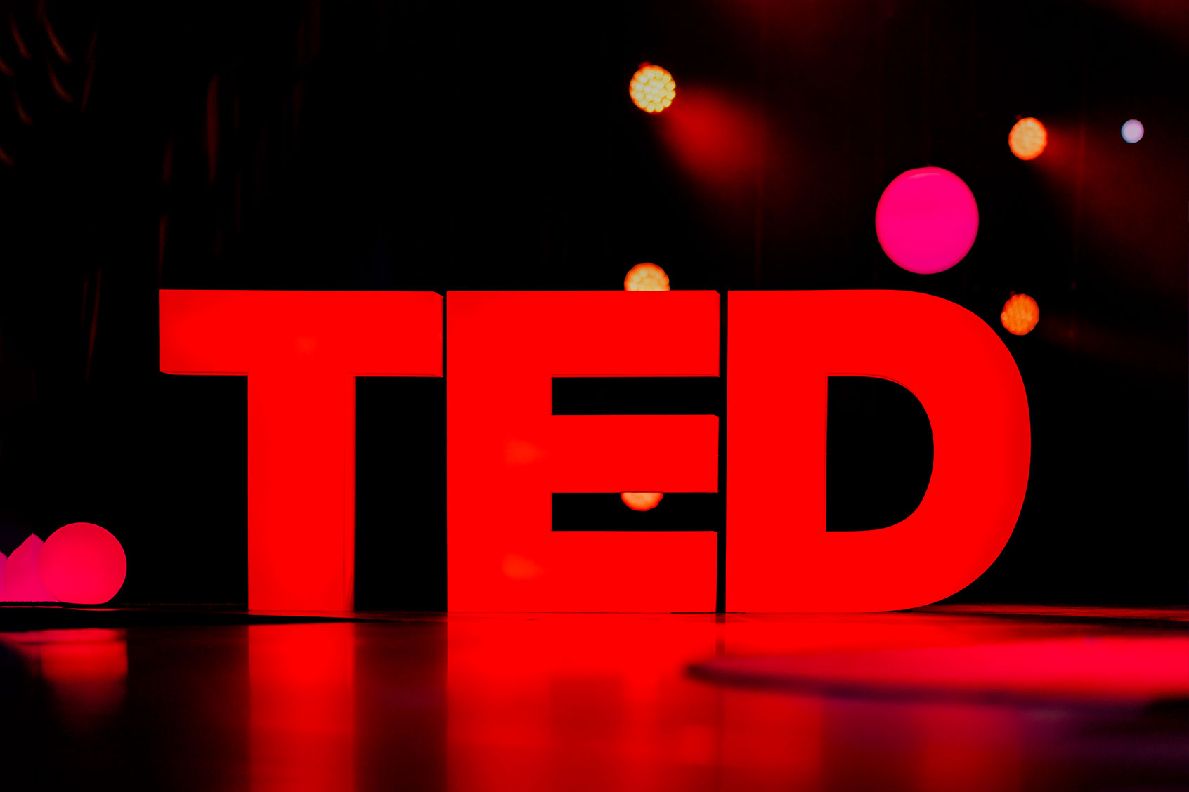 The TED logo stands illuminated on stage in the Community Theater in Vancouver, Canada. (Lawrence Sumulong/Getty Images)
