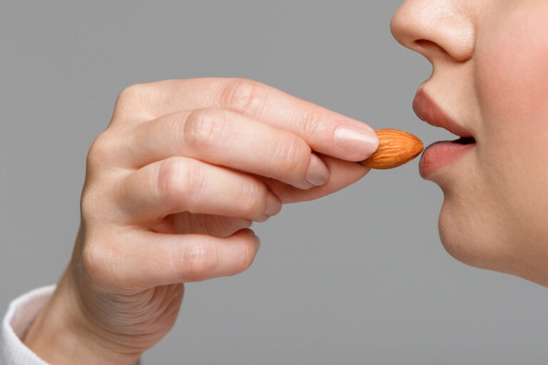 Woman eating an almond (Getty Images/Dima Berlin)