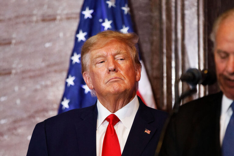 Former US President Donald Trump looks on as South Carolina Governor Henry McMaster addresses the crowd during a 2024 election campaign event in Columbia, South Carolina, on January 28, 2023. (LOGAN CYRUS/AFP via Getty Images)