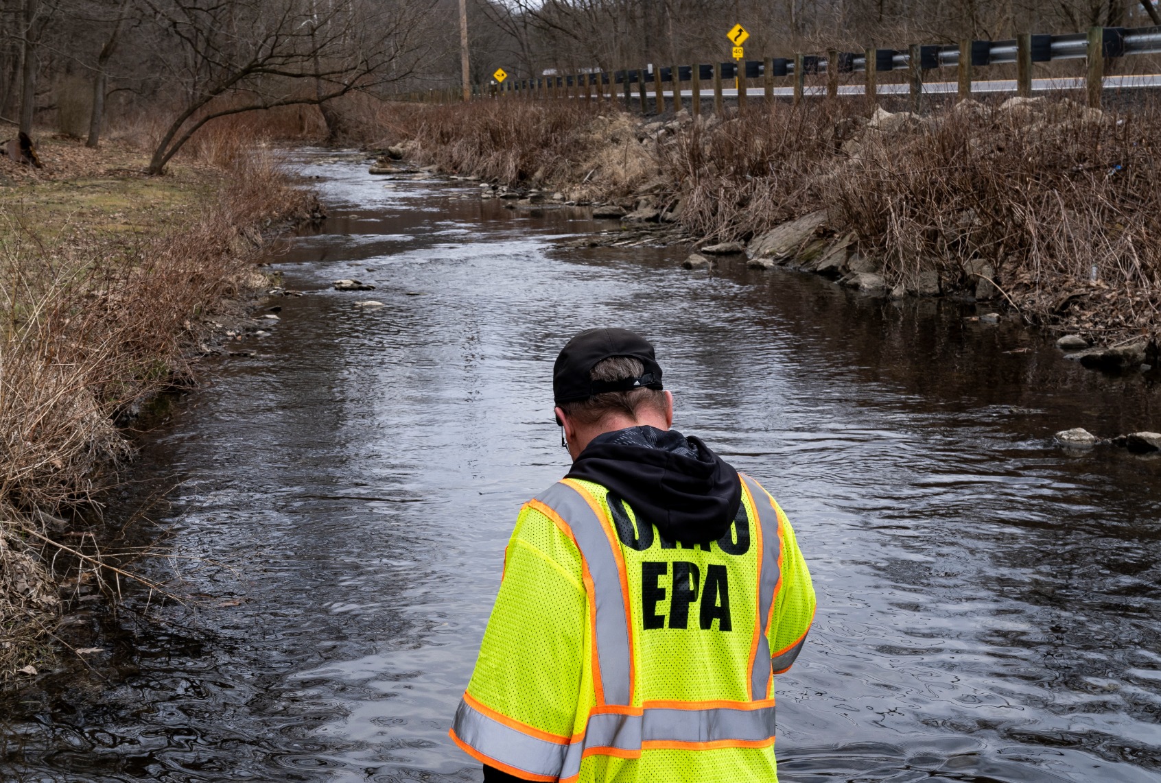 Ron Fodo, Ohio EPA Emergency Response, looks for signs of fish and also agitates the water in Leslie Run creek to check for chemicals that have settled at the bottom following a train derailment that is causing environmental concerns on February 20, 2023 in East Palestine, Ohio. (Michael Swensen/Getty Images)