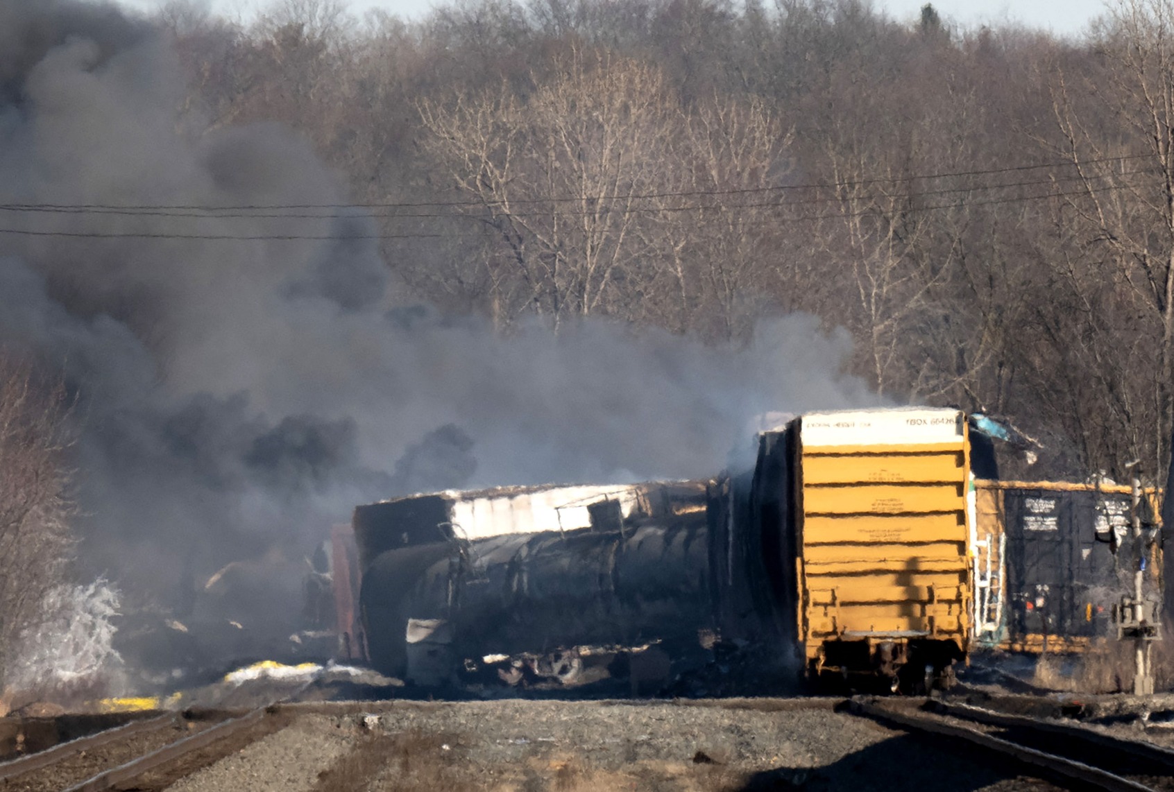 Smoke rises from a derailed cargo train in East Palestine, Ohio, on February 4, 2023. - The train accident sparked a massive fire and evacuation orders, officials and reports said Saturday. No injuries or fatalities were reported after the 50-car train came off the tracks late February 3 near the Ohio-Pennsylvania state border. (DUSTIN FRANZ/AFP via Getty Images)