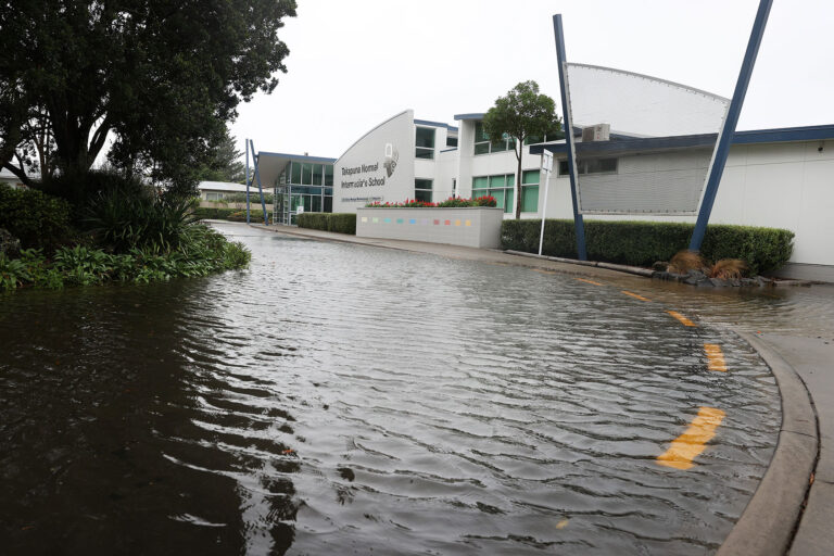 Takapuna Normal Intermediate school entrance is flooded on February 01, 2023 in Auckland, New Zealand. (Fiona Goodall/Getty Images)