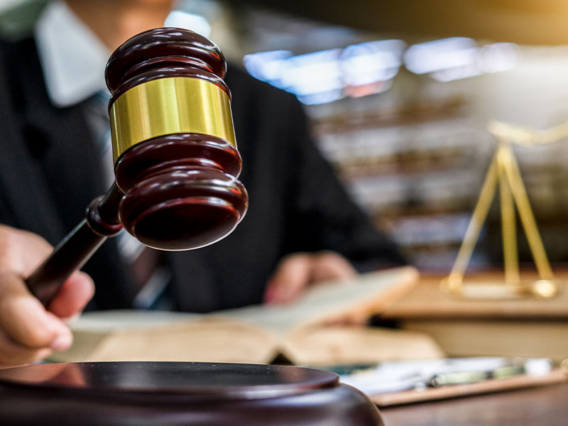 Close up of judge holding gavel (Getty Images/naruecha jenthaisong)