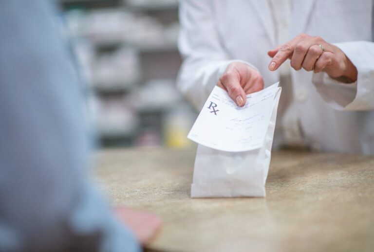 Pharmacist dispenses prescription. (Getty Images/FatCamera)