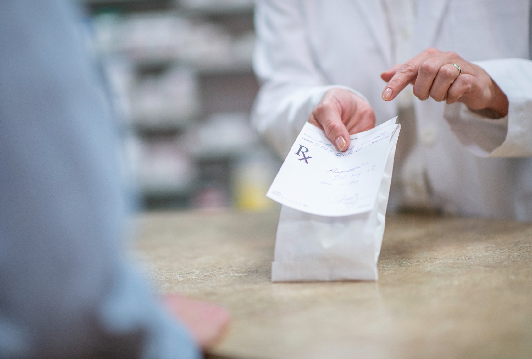 Pharmacist dispenses prescription. (Getty Images/FatCamera)