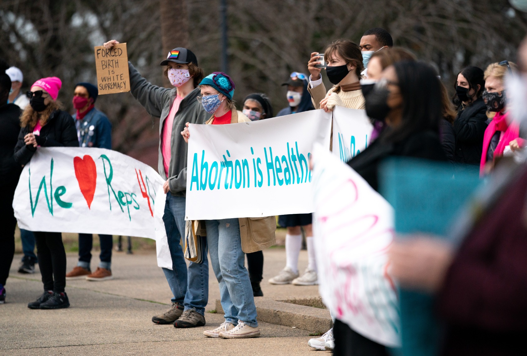 Demonstrators holding placards and banners at South Carolina statehouse in Columbia S.C. on Feb. 17, 2021. (Sean Rayford/SOPA Images/LightRocket via Getty Images)